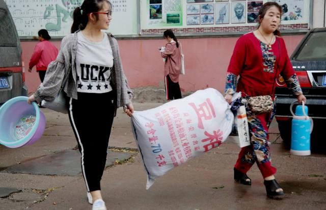 2018年高考结束,家长帮考生搬运物品离校,手抱